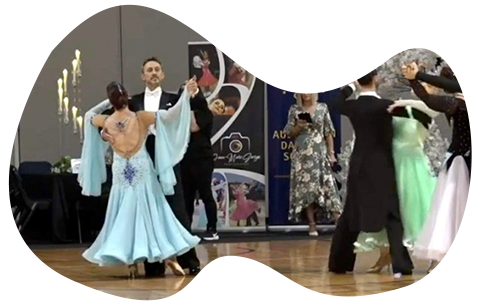 Couple in dance competition lady in blue ballroom dress