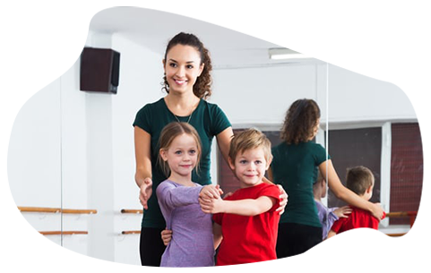 Teacher-helping-two-kids-in-dance-class